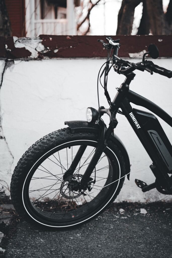 Electric bicycle leaning against a white urban wall