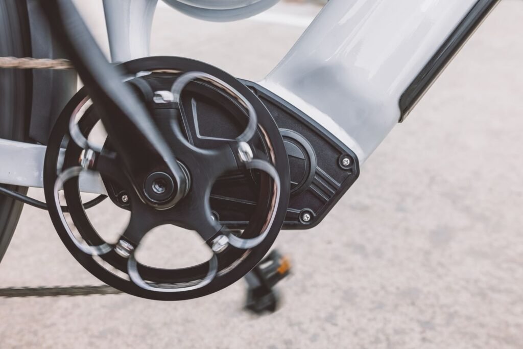 Close-up of an electric bicycle mid-drive motor and chainring